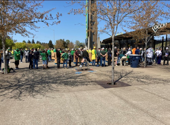 several people wait in line for admission to the Duck spring game